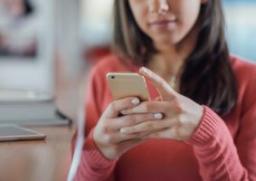 Cute girl texting with her mobile