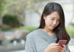 Woman work on cellphone at outdoor