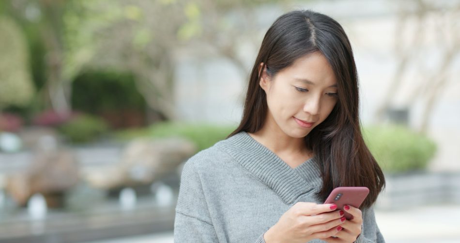 Woman work on cellphone at outdoor